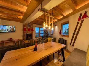 a dining room with a wooden table and chairs at Apartments K.I.D.S. in Vlasic