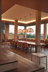 a large dining room with tables and chairs at KAIA Canggu in Canggu