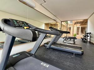 a gym with two tread machines and a mirror at KAIA Canggu in Canggu