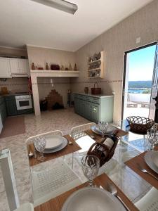 a kitchen with a table with wine glasses on it at Casa Lusa Montargil in Montargil