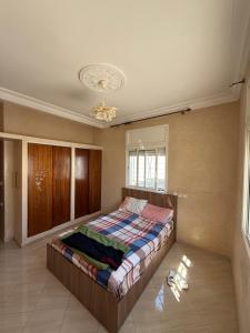 a bedroom with a bed and a chandelier at Appartement Ovalley SAFI in Safi