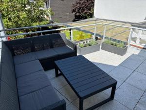a pair of benches and a table on a balcony at Trappe's Maar-Häuschen in Ulmen