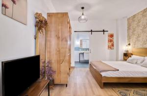 a bedroom with a bed and a flat screen tv at URBAN LOFT VALENCIA in Valencia