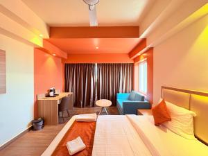 a hotel room with a bed and a chair at Sea Beach Hotel Room with Balconies, Restaurant, Parking & Free Wi-Fi ,Beach Front Location - Fully Air Condition with All Luxury Luxuary Rooms, A Top Rated Hotel In Puri in Puri +16 photos