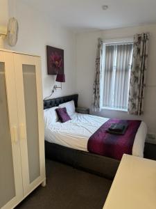 a small bedroom with a bed and a window at The Hotel Blackpool in Blackpool