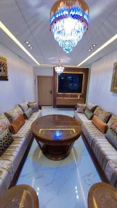 a large living room with a large wooden table at شقة مينا روسيتا in Nador +42 photos