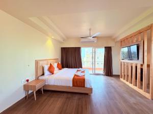 a bedroom with a bed and a large window at Sea Beach Hotel Room with Balconies, Restaurant, Parking & Free Wi-Fi ,Beach Front Location - Fully Air Condition with All Luxury Luxuary Rooms, A Top Rated Hotel In Puri in Puri