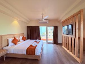 a bedroom with a bed and a large window at Sea Beach Hotel Room with Balconies, Restaurant, Parking & Free Wi-Fi ,Beach Front Location - Fully Air Condition with All Luxury Luxuary Rooms, A Top Rated Hotel In Puri in Puri