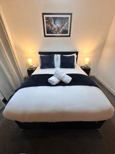 a bedroom with a large bed with towels on it at Harbour Horizons in Edinburgh