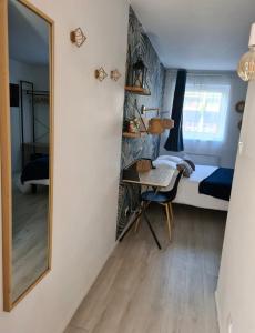 a bedroom with a mirror and a bed and a desk at Charmant studio, hypercentre de St Brieuc in Saint-Brieuc