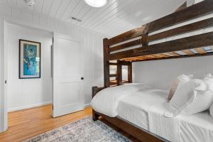 a bedroom with a bunk bed with white sheets and a rug at Dahlia House, 5 BDRM, Walk to town in Highlands +53 photos