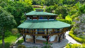 a large building with a green roof in a garden at Solvae EcoHotel in San Jerónimo +51 photos