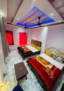 a room with two beds and a table in it at Baba Swami Palace in Varanasi