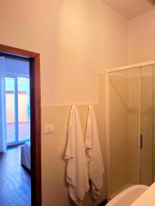 a bathroom with a shower and towels hanging on the wall at Casa Mecenate in Arezzo +15 photos