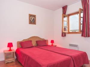 a bedroom with a red bed with two red lamps at Confortable 2 Pièces pour 6 avec Piscine et Proximité Thermes et Navette vers Pistes - FR-1-504-182 in Vignec