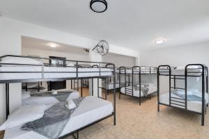 a group of bunk beds in a room at Hacienda M&B Perfect for Groups, with Pool and Spacious Patio in Vega Baja +34 photos