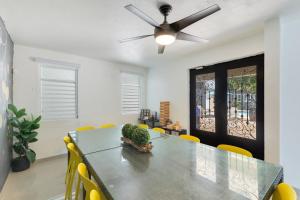 a dining room with a table and a ceiling fan at Hacienda M&B Perfect for Groups, with Pool and Spacious Patio in Vega Baja