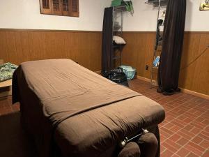 a bedroom with a bed in a room with a tripod at Cozy Space in Central Location in Greendale