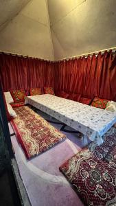 a room with two beds in a tent at Er Targyn 19 in Astana