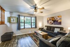 a living room with a couch and a ceiling fan at Hillside Home 5 Mi to the Ark in Williamstown! in Corinth