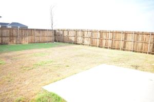 a backyard with a wooden fence and a yard at 4BR Beautiful Home in Princeton in Princeton