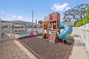 a playground with a slide next to a pool at Family Retreat with Heated Pool, Playground, Ping Pong Table in Jasmine Estates
