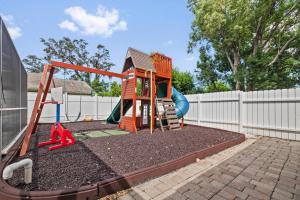 a playground with a slide and a swing at Family Retreat with Heated Pool, Playground, Ping Pong Table in Jasmine Estates
