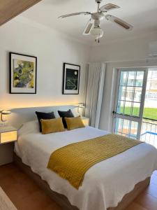 a bedroom with a large bed with yellow pillows at Lotamar19 in Manta Rota