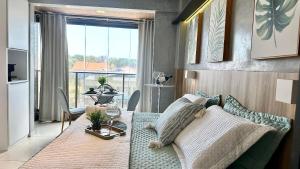 a living room with a couch and a table at (106) Unforgettable Studio in a Modern Space in São Luís