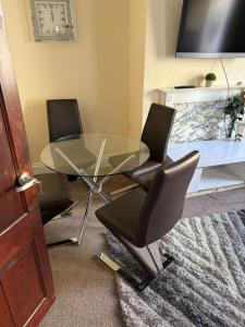 a glass table and two chairs in a room at 2 bedroom House Burnley, Sleeps 5 in Burnley