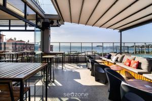a restaurant with tables and chairs and a view of the ocean at Spot Jurere sophistication by the sea - SPJ's in Florianópolis