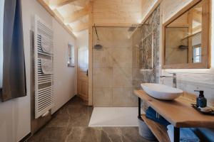 a bathroom with a sink and a shower at Chalets am Duschl-Hof in Bayerbach +47 photos