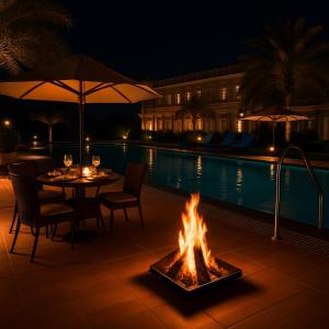 a fire pit next to a pool at night at The Vrindavan Manor - A Boutique Wellness Resort in Lap of Nature # By Elegance Group # in Vrindāvan
