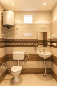 a bathroom with a toilet and a sink at The Vrindavan Manor - A Boutique Wellness Resort in Lap of Nature # By Elegance Group # in Vrindāvan
