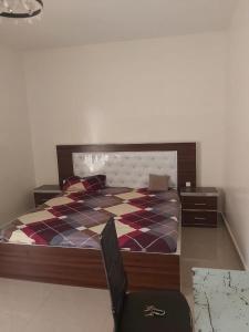 a bedroom with a bed and a chair in it at Al houda in Dakar