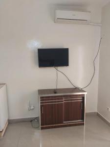 a flat screen tv on a wall in a room at Al houda in Dakar