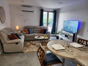 a living room with a couch and a table at 4K-Suite in Kingston