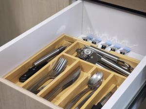 a wooden drawer with some utensils in it at 4K-Suite in Kingston