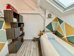 ein Schlafzimmer mit einem Bett und einer geometrischen Wand in der Unterkunft Petite maison de campagne in Giat