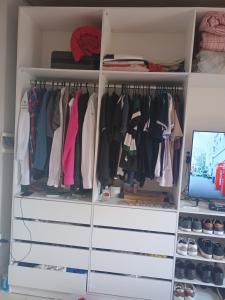 a white closet with a computer monitor in it at Quarto para alugar para cop 30 in Ananindeua