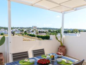 a dining room with a table and a view of the city at Mansarda - SUNSET in Torre Pali +23 photos