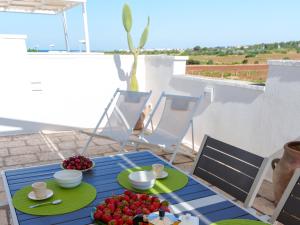 a table with plates of fruit on a patio at Mansarda - SUNSET in Torre Pali