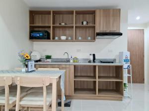 a kitchen with a sink and a table with chairs at HarborPoint Mactan in Mactan