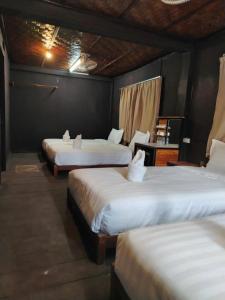 Ένα ή περισσότερα κρεβάτια σε δωμάτιο στο Ban Laos Guesthouse