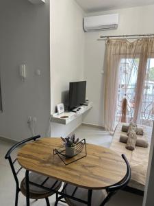 a living room with a table and a couch at Doreta's House Elia in Veria