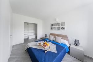 a bedroom with a blue bed with a tray of fruit on it at San Carlo Borromeo in Soiano del Lago