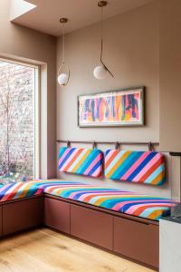 a bedroom with a bed with colorful cushions at Luxurious and Bright Dublin Home in Dublin