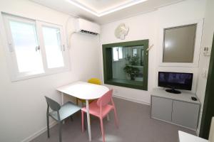 a room with a table and chairs and a television at Stay107 in Seoul +12 photos