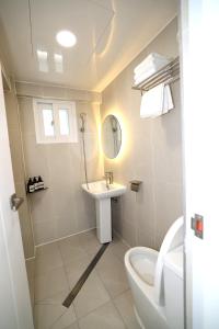 a bathroom with a sink and a toilet and a mirror at Stay107 in Seoul