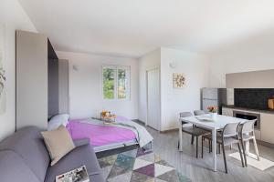 a living room with a bed and a table at San Carlo Borromeo in Soiano del Lago